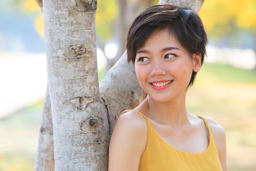 portrait of couples beautiful asian woman standing in blooming flowers park with happiness emotion