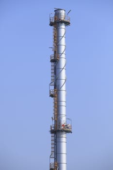 industry chimney tube against clear blue sky use for industrial scene and background