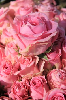 Pink roses in a big bridal bouquet and centerpieces