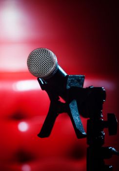 close up texture of microphone in music hall against red luxury background 