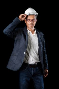 portrait of 45s years old asian engineering  man with studio light on black background