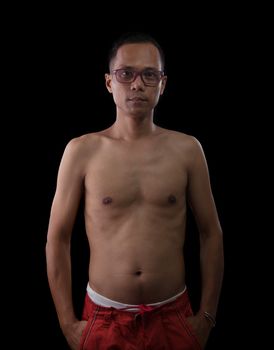 portrait half bodyf with no shirt thin and slim of forty five years old asian man against blac background 