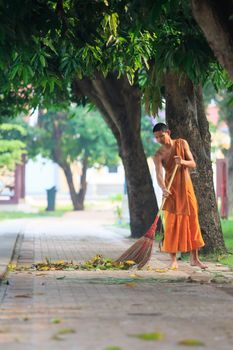 AYUTHAYA THAILAND : MARCH 28 : thai buddhist monk daily cleaning temple area in morning routine working in wat niwesthumaprawat important temple in Ayuthaya Provice central of thailand on march28,2015