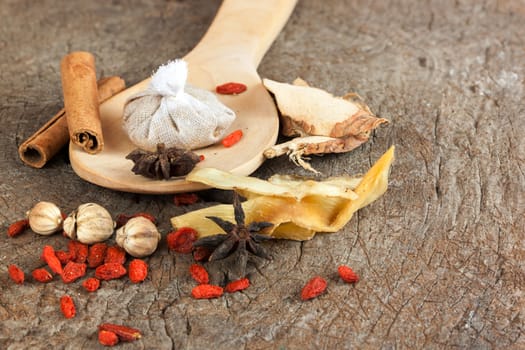 Spices chinese food and herbal wrap for stewed on old wood background