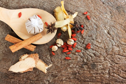 Spices chinese food and herbal wrap for stewed on old wood background