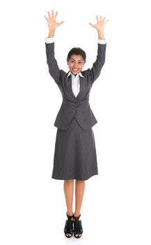 Full length portrait of Indian businesswoman arms raised, standing isolated on white background. 