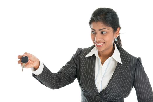 Indian car dealer hand over vehicle key to client, isolated on white background.