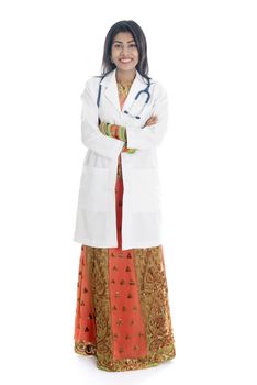 Portrait of full length Indian female medical doctor standing isolated on white background.