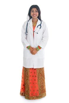 Full length Indian female medical doctor standing isolated on white background.