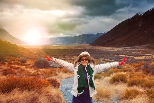 woman traveler wearing winter clothes take a photo with happiness emotion in sun rise natural mountain scene 