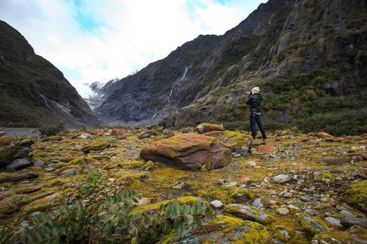 photographer take a photograph in franz josef glacier trail important traveling destination in south island new zealand