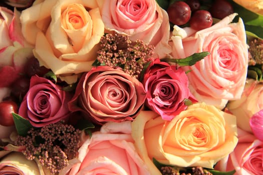 Pastel roses in different shades of pink in a bridal arrangement