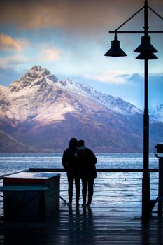silhouette of couples love standing in wakatipu lake view point in queen town south island new zealand at beautiful scenic