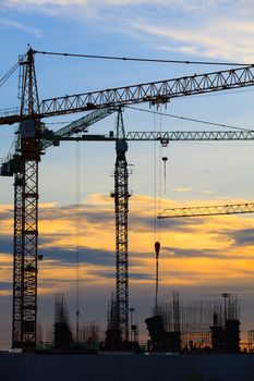 crane of building construction against beautiful dusky sky