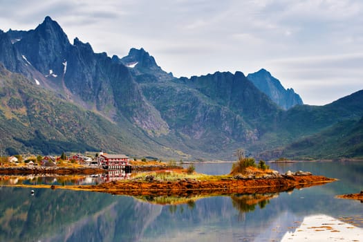 Norway island in fjord. Cloudy Nordic day. Hotel on lofoten island