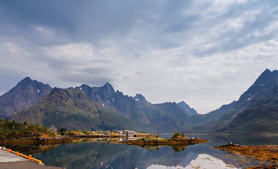 Norway island in fjord. Cloudy Nordic day. Hotel on lofoten island