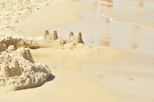 Castle on the beach from sand. Focus in center of image.