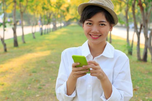 portrait of young beautiful asian woman and smart phone in hand smiling toothy face connecting mobile phone in hand use for people modern life style in digital trend