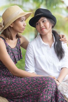 portrait of young asian woman friends talking to consult seriously problem and cheer up to fight a trouble