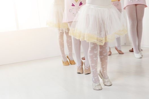 Close-up of a legs little ballerinas in dance studio.