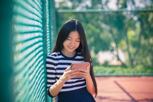 asian girl and computer tablet in hand standing with toothy smiling face use for people and internet connecting ,communication in modern digital lifestyle