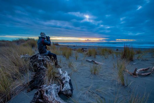 tourist man taking a photography at hokitika beach south island new zealand important traveling destination in west coast 