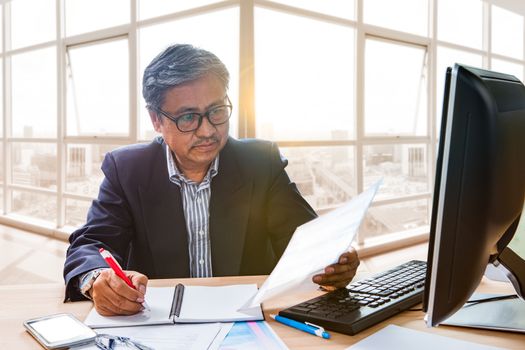 senior working man reading business paper report on working table use for people in office life 