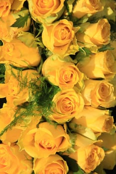 Yellow roses in a floral wedding arrangement