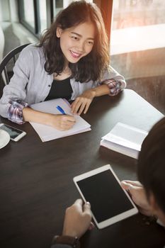 asian woman working on table with business partner