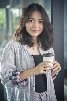 asian woman and hot coffee cup in hand relaxing emotion smiling face