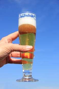 Glass of beer on a sunny summer day, blue sky