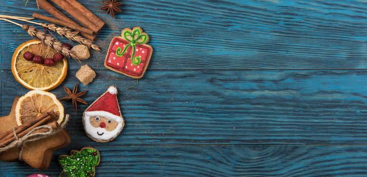 Gingerbreads for new years and christmas on wooden background, xmas theme