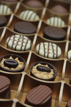 Chocolate candies in a golden gift box