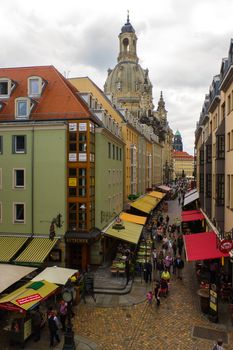 DRESDEN, GERMANY - SEPTEMBER 21, 2013: the Pedestrians in the Munzgasse alleyway. The historic cobblestone alley is lined with many of Dresdens most famous restaurants and cafes.