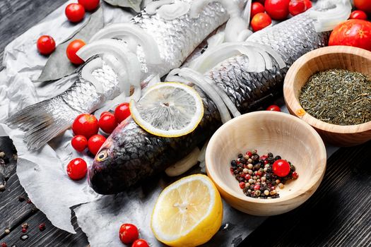 Carcass raw fish on the kitchen table with spices