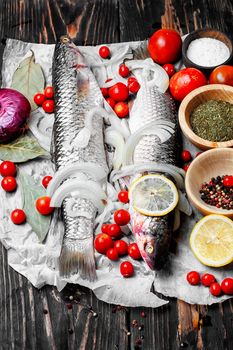 Carcass raw fish on the kitchen table with spices