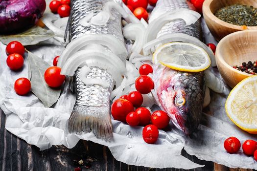 Carcass raw fish on the kitchen table with spices