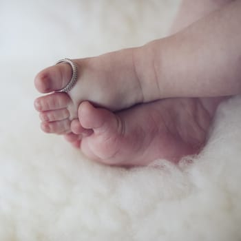 Baby feet with the mothers ring