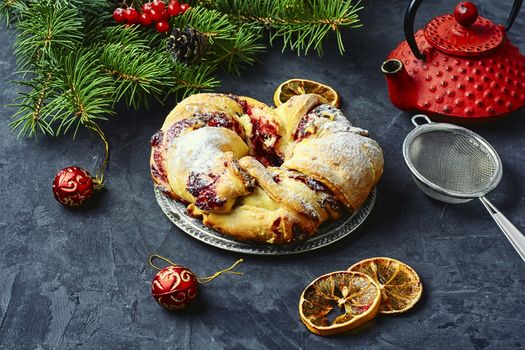 Christmas cookies on platter,red stylish kettle and spruce branch