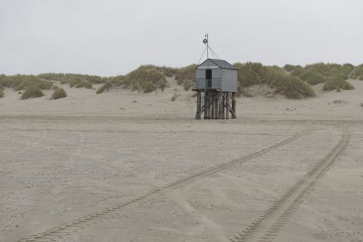 The sea cottage of Terschelling is from the end of 2015 posted near pole 24 on the North Sea Beach at the dunes on a larger and more secure distance from the North Sea on a new location. Picture was taken on a foggy and drizzly autumn day
