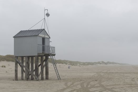 The sea cottage of Terschelling is from the end of 2015 posted near pole 24 on the North Sea Beach at the dunes on a larger and more secure distance from the North Sea on a new location. Picture was taken on a foggy and drizzly autumn day
