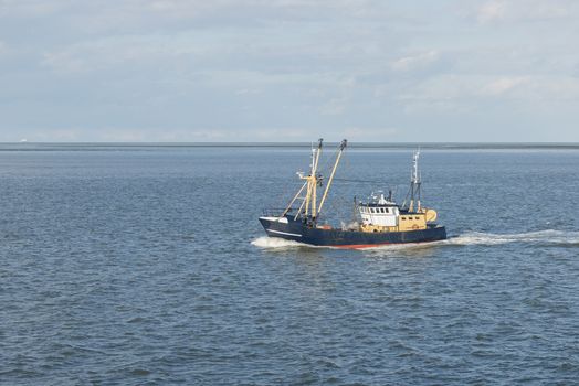 Fishing boat on the Wadden Sea near the island of Vlieland in the North of the Netherlands
