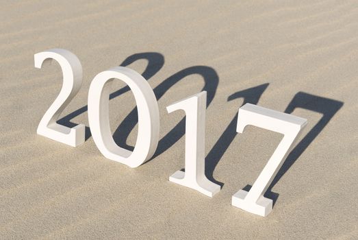 White wood figures on a beach forming the text two thousand seventeen as conceptual welcoming of the coming new year
