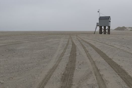 The sea cottage of Terschelling is from the end of 2015 posted near pole 24 on the North Sea Beach at the dunes on a larger and more secure distance from the North Sea on a new location. Picture was taken on a foggy and drizzly autumn day
