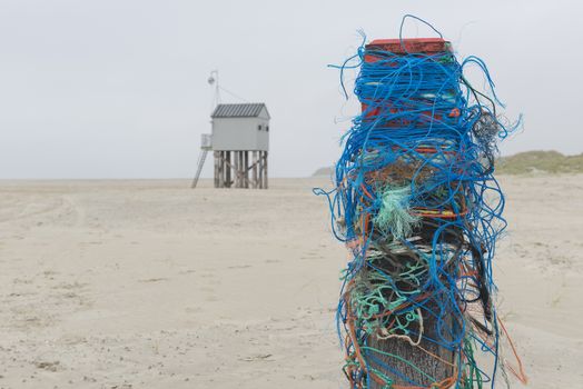 The sea cottage of Terschelling is from the end of 2015 posted near pole 24 on the North Sea Beach at the dunes on a larger and more secure distance from the North Sea on a new location. Picture was taken on a foggy and drizzly autumn day
