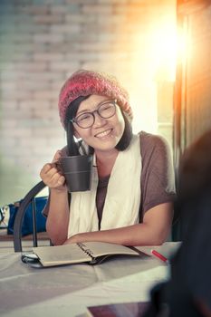 asian woman toothy smiling face with happiness emotion discussion in cofee shop ,relaxing emotion ,modern lifestyle of people