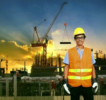 asian construction site worker smiling face and building construction site background