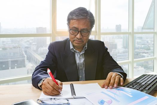 senior business man working on office table