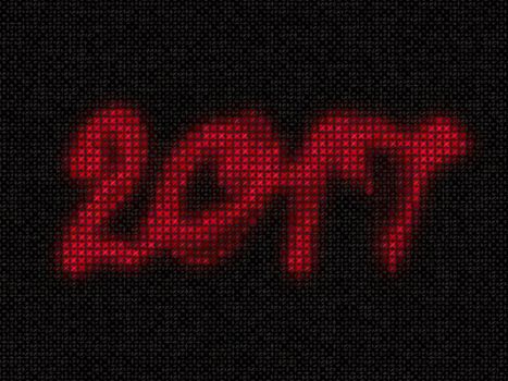 Happy new year 2017 isolated embroidered knit numbers lettering on black cloth background.