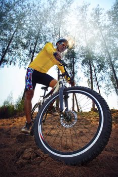young man riding mountain bike mtb in jungle track use for sport extreme adventure healthy and holiday activities life style 